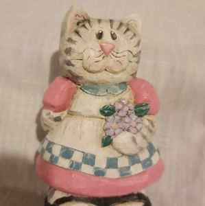 Midwest  cat wearing pink dress holding flowers